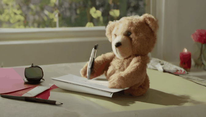 a teddy bear writing a letter